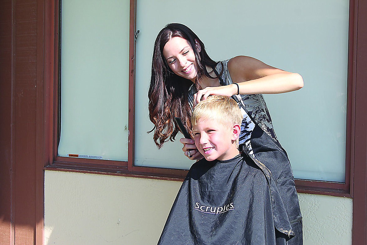 &lt;p&gt;Aidan Rich, 7, gets a hair cut from Andra Sweet.&lt;/p&gt;