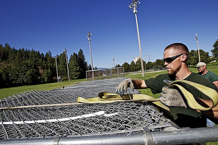 &lt;p&gt;JEROME A. POLLOS/Press Eric Schenkenberger, with the City of Coeur d'Alene, secures a strap to a trailer load of chain link fence sections that were removed Thursday from McEuen Field. City parks and maintenance workers have begun collecting supplies and equipment from the park to reuse in other facilities.&lt;/p&gt;