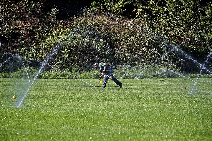 &lt;p&gt;JEROME A. POLLOS/Press Nick Arellano, a maintenance worker with the City of Coeur d'Alene, marks sprinkler heads with flags Thursday for removal as crews begin to salvage equipment and supplies from McEuen Park for reuse in other facilities within the city.&lt;/p&gt;