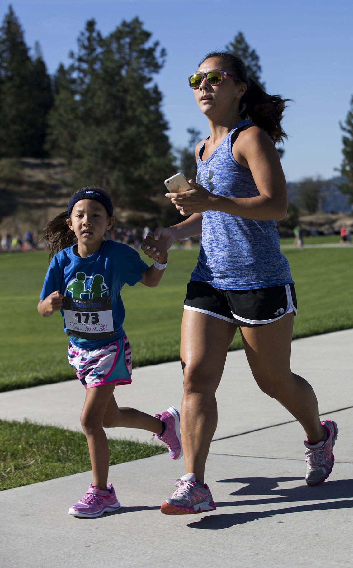 &lt;p&gt;LOREN BENOIT/Press Hayden resident Lindsey Pooler holds the hand of her daughter Averie, 5, as her daughter runs in the IronKids Coeur d'Alene Fun Run on Saturday at McEuen Park.&lt;/p&gt;