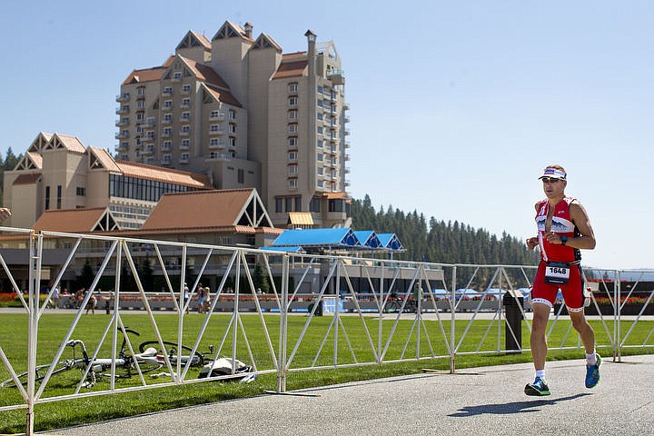 &lt;p&gt;JAKE PARRISH/Press Eric Stimach of Belleville, Mich. treks through the first loop of the 26.2 mile run of the Ironman Coeur d'Alene triathlon on Sunday. More than 1,300 athletes from around the world participated in the annual race.&lt;/p&gt;