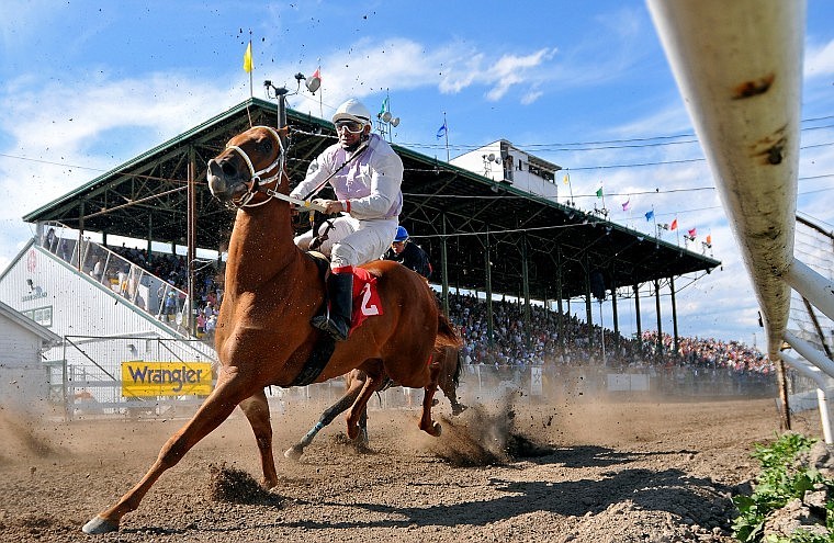 Ruben Camacho rounds the corner on his horse Buford Tucker during Saturday&#146;s horse races at the Northwest Montana Fair. Horse racing returned to the fair for the first time since 2005 and attracted a big crowd Saturday afternoon. Eight more races are scheduled today during the final day of the fair. Gates open at 11 a.m. and racing starts at 1 p.m.