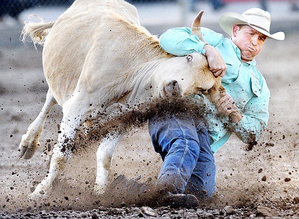 Nick Stubblefield of Choteau, Mont., competes in the Steer Wresting competes competition on Friday at the Northwest Montana Fair in Kalispell.