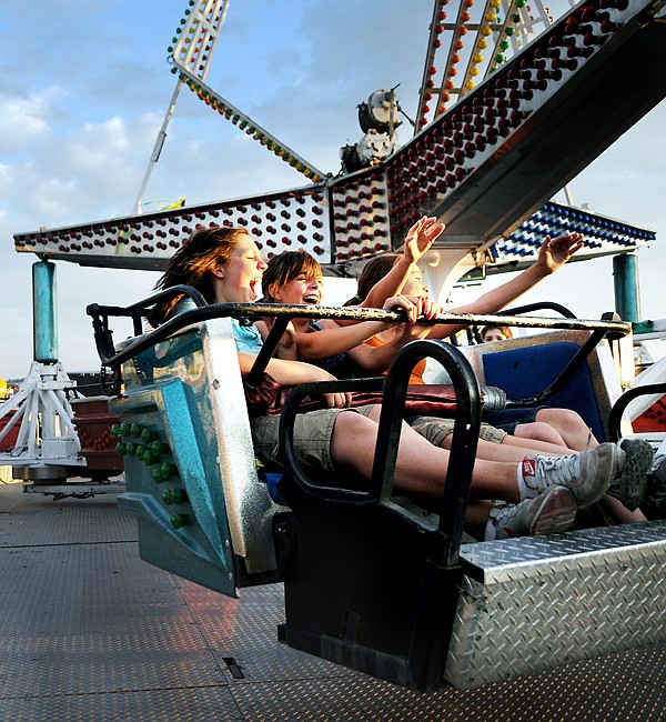 Miriam Talus, 13, of Lakeside, left to right, Katey Deist, 12, and Sierra Rivera, 13, both of Kalispell, scream as they ride one of the rides on Wednesday at the Northwest Montana Fair.