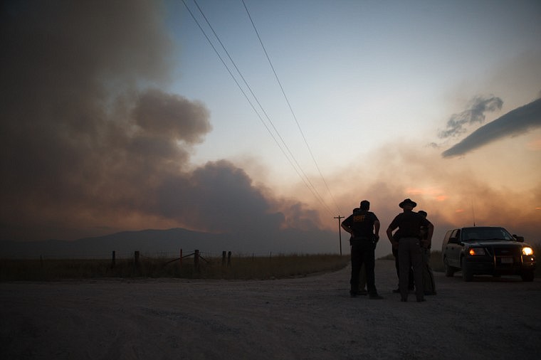 &lt;p&gt;Patrick Cote/Daily Inter Lake Lake County Sheriff's deputies watch as The West Garceau Fire burns approximately 2,000 acres Tuesday evening near Big Arm. Fifteen people from the Irvin Flats area were evacuated and are currently staying at the Big Arm Fire Station. Tuesday, Aug. 14, 2012 in Big Arm, Montana.&lt;/p&gt;