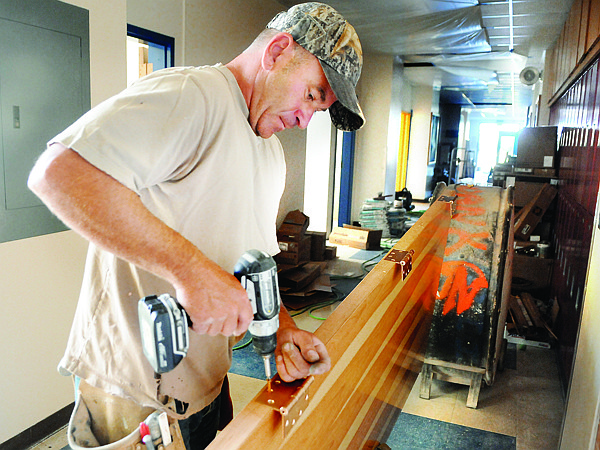 Lance Grider of Whitefish works on installing new fire doors on Thursday at Cayuse Prairie School.