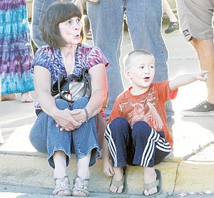 &lt;p&gt;Gigi Scofield, left, and her grandson Peyton Scofield, marvel at Mineral Avenue's parade of show cars Friday evening.&lt;/p&gt;