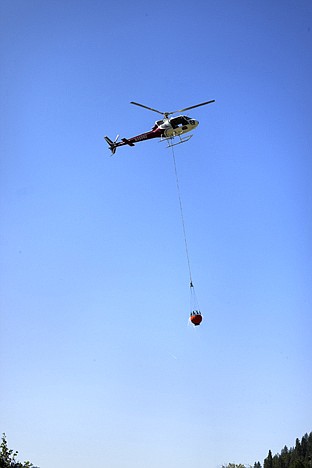 &lt;p&gt;A helicopter scoops up water from a creek near Wold Lodge Tuesday to drop on a four acre wildfire just east of Coeur d&#146;Alene, Idaho near Wolf Lodge. The fire is called the Marie Creek Fire and is located along Marie Creek two and a half miles north of I-90 and five miles east of the Wolf Lodge exit.&lt;/p&gt;