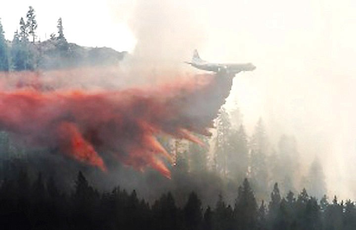 A firefighting aircraft drops retardant in the Hidden Valley area as the Taylor Bridge wildfire continues to burn on Friday.