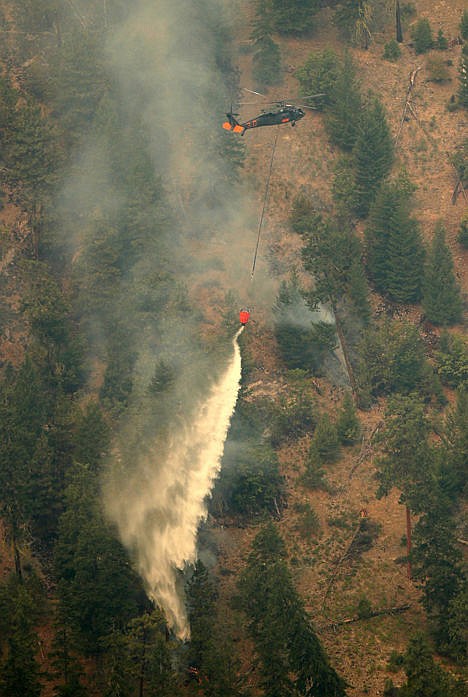 &lt;p&gt;In this aerial photo, a helicopter takes water from Lake Chelan to drop on a wildfire in Chelan, Wash., Thursday. Firefighters on several fronts are fighting against raging wildfires advancing on towns in the north-central part of the state.&lt;/p&gt;