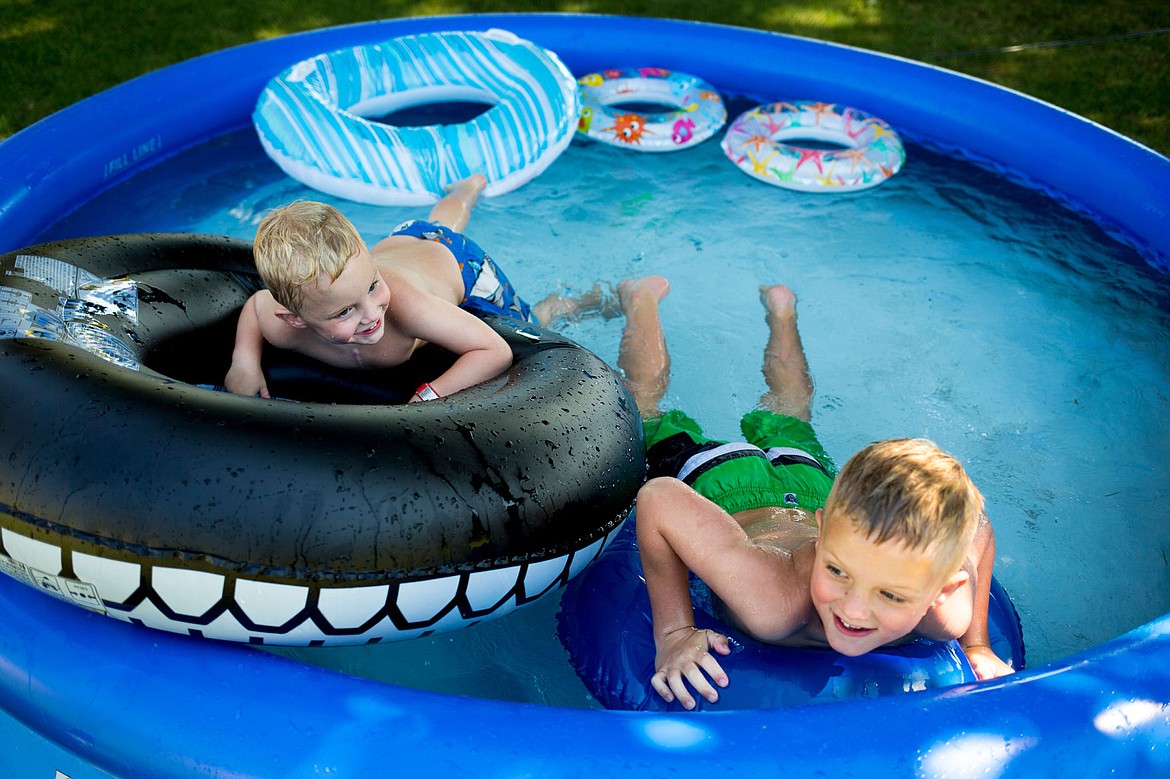 &lt;p&gt;JAKE PARRISH/Press Eli Ashby, 4, and his brother Andrew, 7, play in a pool on Friday in their grandparents' backyard in Dalton Gardens.&lt;/p&gt;