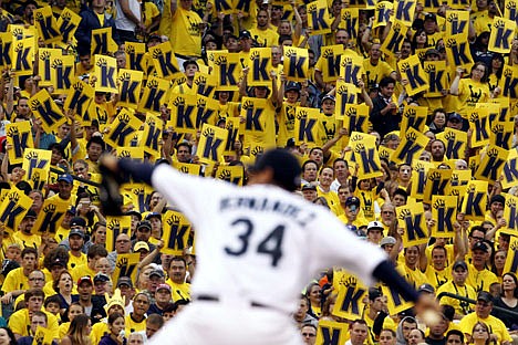 &lt;p&gt;Fans stand to cheer as Seattle Mariners starting pitcher Felix Hernandez throws against the Cleveland Indians in the third inning of a baseball game, Tuesday, Aug. 21, 2012, in Seattle. (AP Photo/Elaine Thompson)&lt;/p&gt;