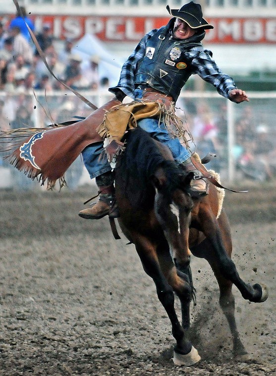 George Gillespie of Midland, Ore., holds on for the ride during bareback riding.