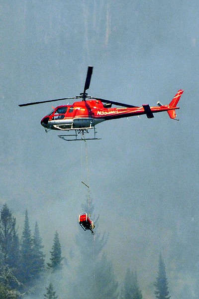 &lt;p&gt;A helicopter carries a helitorch Friday to ignite a burnout on
the South Fork Lost Creek Fire.&lt;/p&gt;