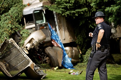 &lt;p&gt;Sgt. Kevin White, with the Idaho State Police, surveys the scene of a fatal accident Monday where a semi-truck crashed down an embankment of Interstate 90 just west of the Highway 41 interchange in Post Falls.&lt;/p&gt;