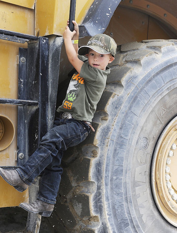 &lt;p&gt;Walter Gardner of Kalispell hangs from a front end loader after getting to drive it at Gravelpalooza. The 4-year-old made sure nobody helped him climbing down. (Aaric Bryan/Daily Inter Lake)&lt;/p&gt;