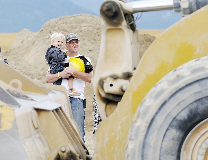 &lt;p&gt;Jake Ek holds his son Vance, 2, as they watch his other son Reid,6, help drive a front end loader. (Aaric Bryan/Daily Inter Lake)&lt;/p&gt;