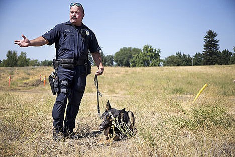 &lt;p&gt;Post Falls Police officer Frank Bowne answers questions about Koda, laying down, a police service dog that is being forced into early retirement due to a neurological disorder, Saturday at the Cops-n-Kids and Rodders-n-More Open house. Bowne, Koda&#146;s handler, demonstrated Koda&#146;s ability to find small objects in a field at the open house.&lt;/p&gt;