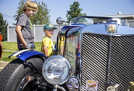 &lt;p&gt;At left, Braxton, 9, and Cameron Cerise, 3, scope out a restored 1951 MGTD Saturday at the fifth annual Cops-n-Kids and Rodders-n-More Open House at the Post Falls City police department. The MGTD is a 20-year restoration project by Bob Hughes and Ray Peterson.&lt;/p&gt;