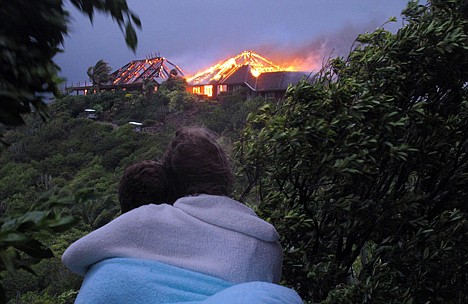 &lt;p&gt;An unidentified couple looks toward British entrepreneur Sir Richard Branson's luxury home, on Necker Island, in the Caribbean, as it burns Monday. Guests including Academy Award-winning actress Kate Winslet escaped uninjured when fire destroyed the home during a tropical storm Monday. The Virgin Group boss said about 20 people, including Winslet and her children, were staying in the eight-bedroom Great House on Necker, his private isle in the British Virgin Islands.&lt;/p&gt;