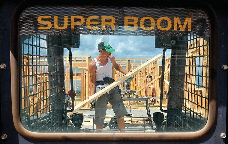 David Selders lifts up a board to be cut at Silverbrook Estates.