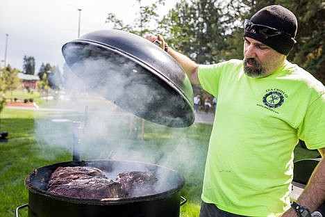 &lt;p&gt;Chris Patterson of Coeur d'Alene lifts the lid of his 55-gallon &quot;Ugly Drum&quot; bar-be-que to check on pork shoulder Friday at McEuen Park. Patterson, along with over 20 other teams of bar-be-que enthusiasts, will be cooking their best food at the Idaho BBQ State Championship on Sunday in McEuen Park. The competition is open to the public.&lt;/p&gt;