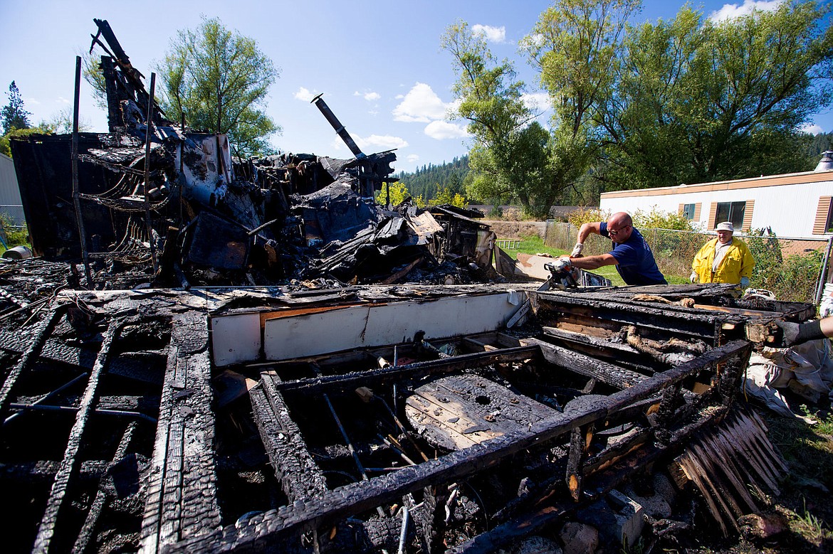 &lt;p&gt;Northern Lake Fire District Firefighter Justin Brodin uses a chain saw on Tuesday to separate the charred frame of a wall as crews investigate a early morning Tuesday fire that destroyed a home in Rathdrum.&lt;/p&gt;