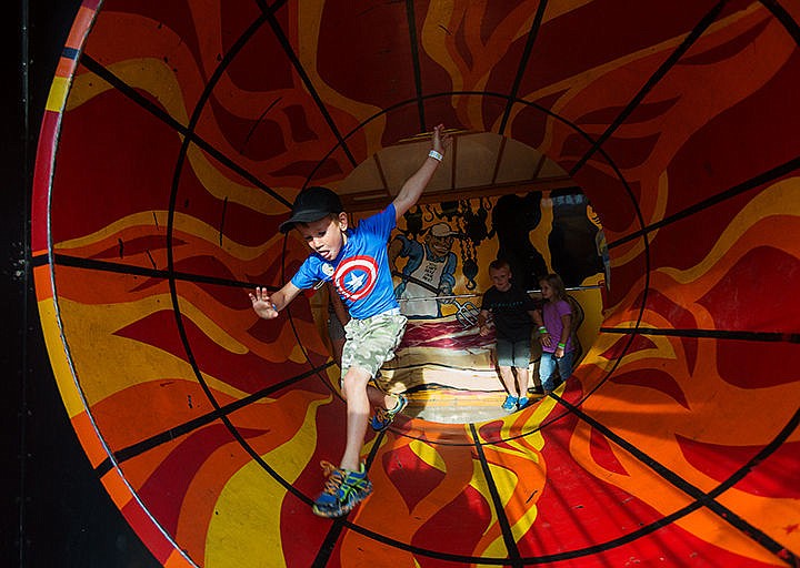 &lt;p&gt;SHAWN GUST/Press&lt;/p&gt;&lt;p&gt;Parker Sterling, 5, of Hayden, tries to keep his balance while running through a spinning feature of a fun house amusement ride Friday at the North Idaho Fair in Coeur d&#146;Alene.&lt;/p&gt;