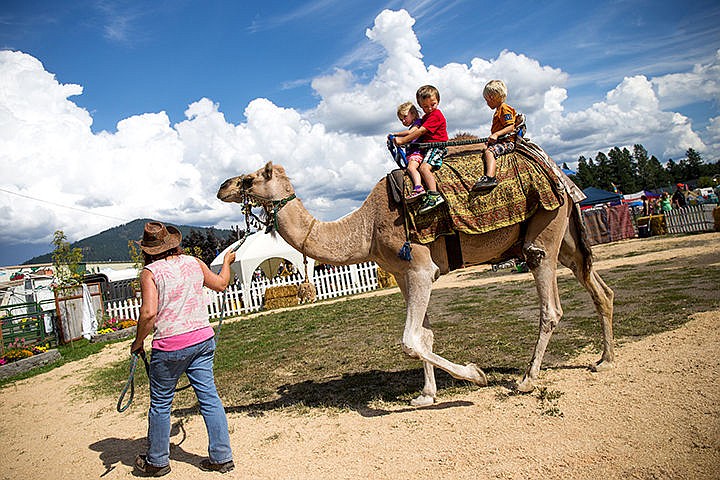 &lt;p&gt;TESS FREEMAN/Press&lt;/p&gt;&lt;p&gt;Jeannene Christ&#160;from the Cute as a Bug Mobile Petting Zoo gives Ellie Rivadeneira, 2,&#160; Emmet Rivadeneira, 3&#160;and Ryder Weingart, 3&#160;on her camel Tex at the North Idaho Fair and Rodeo on Thursday afternoon.&lt;/p&gt;