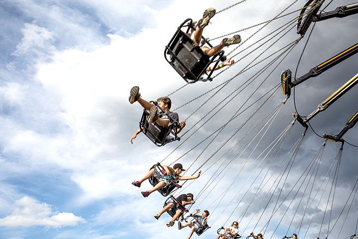&lt;p&gt;JAKE PARRISH/Press&lt;/p&gt;&lt;p&gt;Kids check out the view and wave to their friends while sailing through the air on a swing ride Thursday at the North Idaho Fair and Rodeo at the Kootenai County Fairgrounds.&lt;/p&gt;