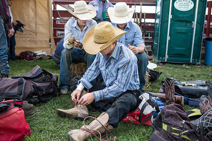 &lt;p&gt;JAKE PARRISH/Press&lt;/p&gt;&lt;p&gt;Young cowboys lace up their boots and tape their hands as they prepare to ride 1,800 pound bulls at the Xtreme Bulls rodeo show Thursday at the North Idaho Fair and Rodeo. The Fair continues through Sunday at the Kootenai County Fairgrounds.&lt;/p&gt;