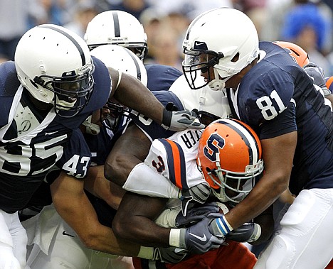 &lt;p&gt;Syracuse's Delone Carter (3) is tackled by Penn State defenders, from left, Ollie Ogbu (85), Josh Hull (43), Bani Gbabyu (15), and Jack Crawford (81), during a game Sept. 12, 2009 in State College, Pa.&lt;/p&gt;