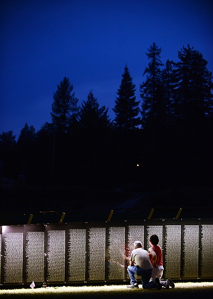 <p>Linda Biskup and Tom Callahan of Lincoln, Neb., examine The Moving Wall Vietnam Veterans Memorial on Thursday, August 22, in Whitefish. (Brenda Ahearn/Daily Inter Lake)</p>