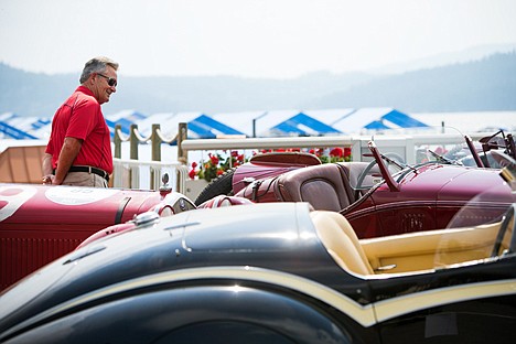 &lt;p&gt;Bob Hilton checks our a handful of Alfa Romeos on exhibit Friday on the grounds in front of the Coeur d'Alene Resort. More than 30 classics by the Italian car company were in Coeur d'Alene as part of the 8C Tour of the Rockies.&lt;/p&gt;