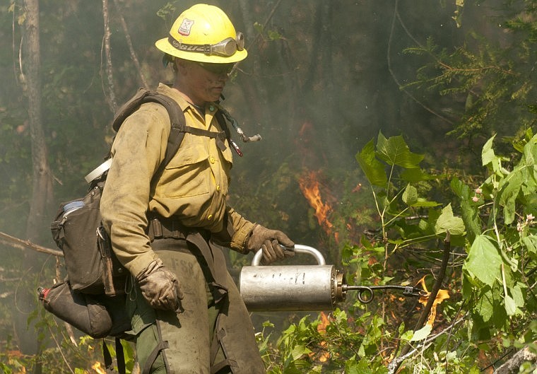 &lt;p&gt;Blake Lindsay of the Idaho Panhandle Hot Shots uses a drip torch
to set back fires Tuesday at the South Fork Lost Creek Fire above
Swan Lake.&lt;/p&gt;