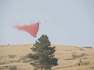 &lt;p&gt;A Single-engine air tanker (SEAT) plane dumps a red cloud of retardant on the West Garceau fire. Air drops such as this one are able to slow the fire's rate of spread, allowing crews time to establish firelines.&lt;/p&gt;