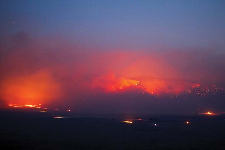 &lt;p&gt;This 10-second exposure shows the red glow of The West Garceau Fire burning Tuesday night near Big Arm.&lt;/p&gt;