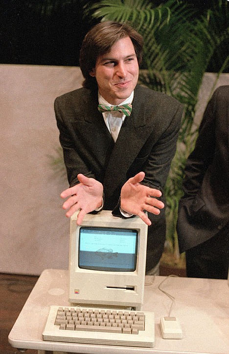 <p>FILE - In this Jan. 24, 1984 file photo, Steven Jobs, chairman of the board of Apple Computer, leans on the new Macintosh personal computer following a shareholder's meeting in Cupertino, Ca. Apple Inc. on Wednesday, Aug. 24, 2011 said Jobs is resigning as CEO, effective immediately. He will be replaced by Tim Cook, who was the company's chief operating officer. It said Jobs has been elected as Apple's chairman. (AP Photo/Paul Sakuma, File)</p>