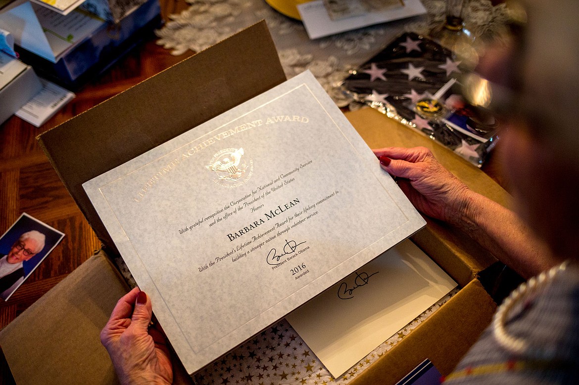 &lt;p&gt;McLean holds up the Lifetime Achievement Award she received from President Obama for her decades of volunteer work.&lt;/p&gt;