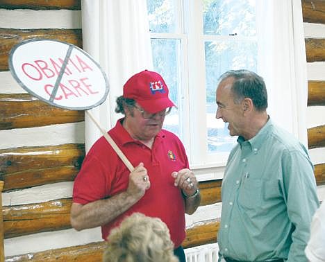 Bob Linscott discusses Obama care with Rep. Walt Minnick, D-Idaho, prior to Monday&#146;s town hall meeting. (Photo by DAVID KEYES)