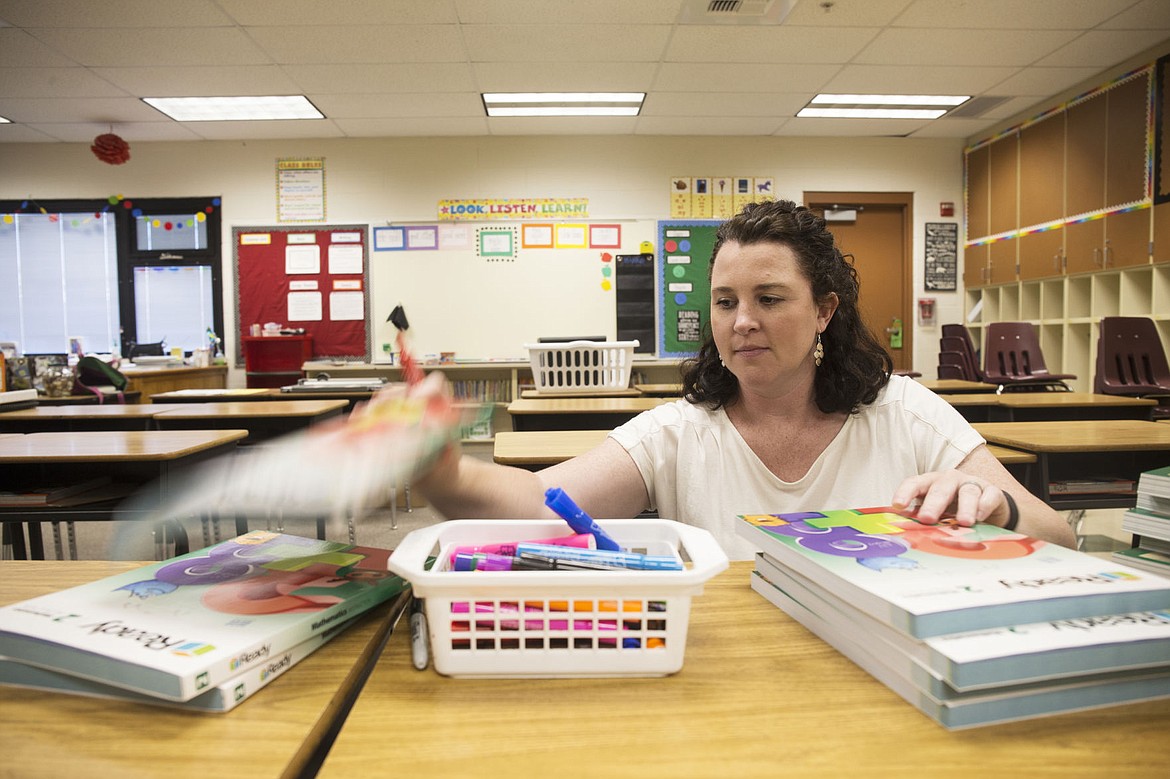 &lt;p&gt;Second-grade Atlas Elementary School teacher Mindy Banks organizes math instruction books inside her classroom on Wednesday.&lt;/p&gt;