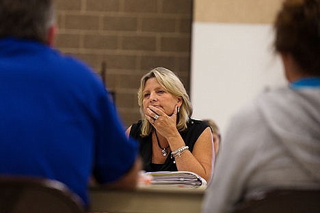 &lt;p&gt;Kelly Ostrom, human resources director and chief negotiator for the Coeur d&#146;Alene School District, listens to a case by the Coeur d&#146;Alene Education Association representatives as contract negotiations continue Monday at Woodland Middle School.&lt;/p&gt;