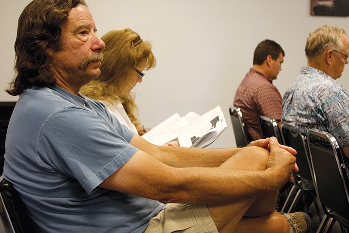 Jeff and Jennifer Powell, of Moses Lake, listen during a rates
hearing Tuesday in Moses Lake.