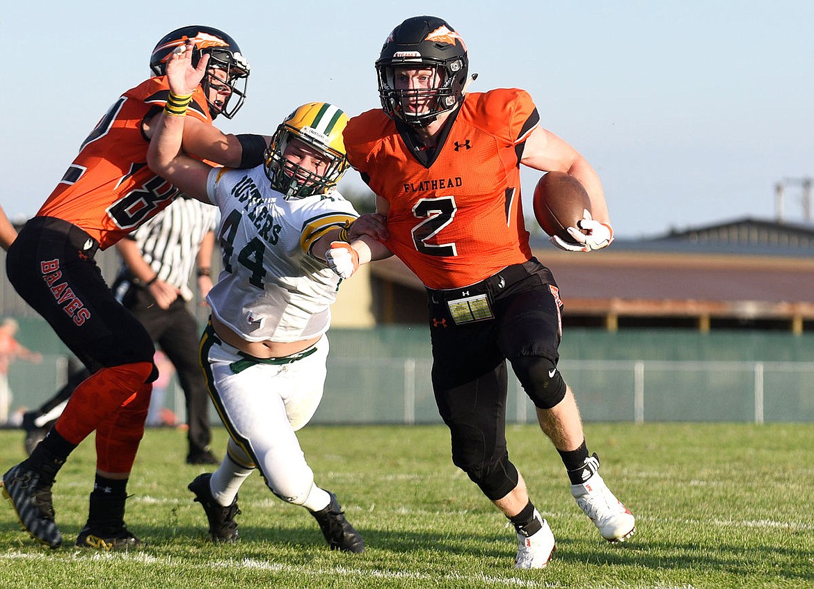 &lt;p&gt;Flathead receiver Seth Adolph gets a block from Austin Demars as he escapes the grasps of C.M. Russell Carter Durnell on a long run during the first quarter at Legends Stadium on Friday, Aug. 26. (Aaric Bryan/Daily Inter Lake)&lt;/p&gt;