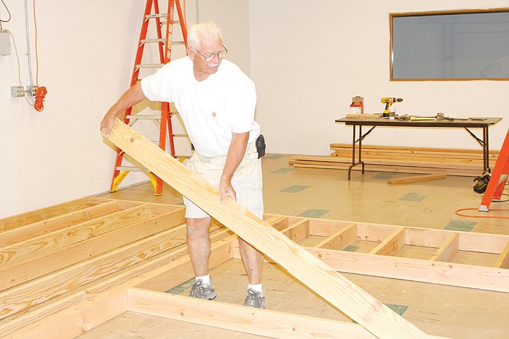 Mark Slouber, head of field operations for iFiber
Communications, works on a wall frame for a new TV studio at the
Ephrata business Tuesday.