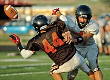 Junior Robbie Gauthier hits J.J. Tanner during the Ronan Orange/Black Scrimmage last Friday in Ronan.