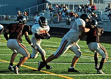 Senior lineman Charles Hunter clears the way for senior running back Lucas Black during the Ronan Orange/Black Scrimmage.