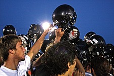 The Ronan football team huddles up after the Orange/Black Scrimmage.