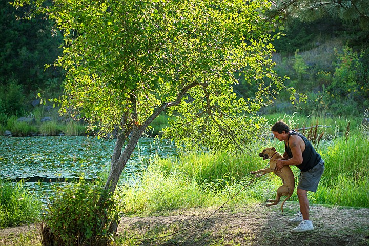 &lt;p&gt;SHAWN GUST/Press Billy Jemison, of Coeur d'Alene, plays with his mixed breed puppy Monday after setting his fishing lines at Fernan Lake.&lt;/p&gt;