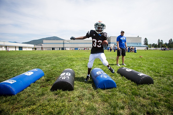 &lt;p&gt;SHAWN GUST/Press Trey McArthur, 11, steps over obstacles during a running back footwork drill at Coeur d'Alene High.&lt;/p&gt;